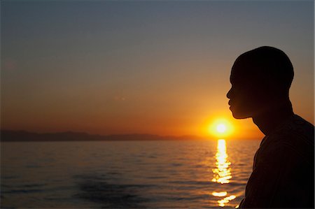 simsearch:862-03713009,k - Malawi, Lake Malawi; sunset over the lake a local boatmen outlined by the setting sun. Stock Photo - Rights-Managed, Code: 862-03713009