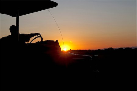 sunset safari - Malawi, Upper Shire Valley, Liwonde National Park. At sunset a tour guide points out of a shaded safari vehicle. Stock Photo - Rights-Managed, Code: 862-03713053