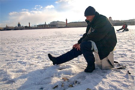 fishing winter - Russia, St.Petersburg; Fisherman on the frozen Neva river during Winter. Stock Photo - Rights-Managed, Code: 862-03713220