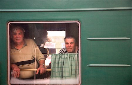Russia, Siberia; Trans-Siberian; Two elderly men looking across from a moving train, Irkutsk Fotografie stock - Rights-Managed, Codice: 862-03713336