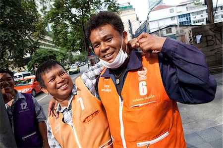 simsearch:862-06543131,k - Bangkok, Thailand. Tuk Tuk drivers socializing on the street in Bangkok Stock Photo - Rights-Managed, Code: 862-03713788