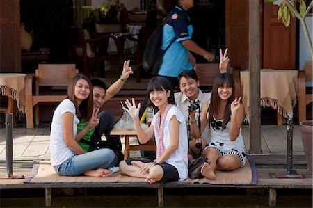 Bangkok, Thailand. Young Thai people waving from the dock along a river bank Stock Photo - Rights-Managed, Code: 862-03713807