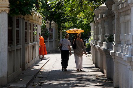 simsearch:862-06543131,k - Two women walking under an umbrella in Bangkok Thailand Stock Photo - Rights-Managed, Code: 862-03713844