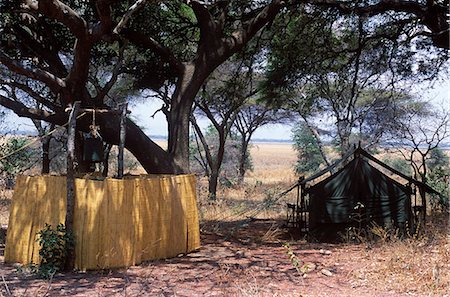 safari lodges - Tanzania, Katavi National Park.  Guest tent with reeded shower enclosure at Chada Camp. Stock Photo - Rights-Managed, Code: 862-03713919