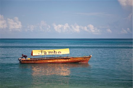 swahili - Tanzania, Zanzibar. A boat with 'Jambo', Swahili for 'hello', floats off the coast of Zanzibar's Stone Town Stock Photo - Rights-Managed, Code: 862-03713954