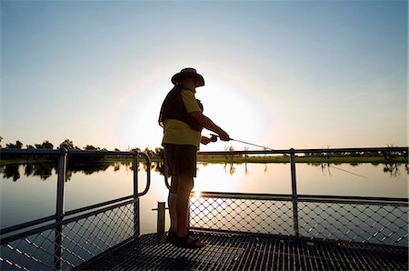fishing silhouette - Australia, Northern Territory, Kakadu National Park, Cooinda. Fly fishing for Barramundi at the Yellow Water Wetlands. (PR) Stock Photo - Rights-Managed, Code: 862-03736309
