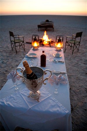 Botswana, Makgadikgadi. A romantic dinner for two is set up at sunset on the empty Makgadikgadi saltpans. Stock Photo - Rights-Managed, Code: 862-03736362