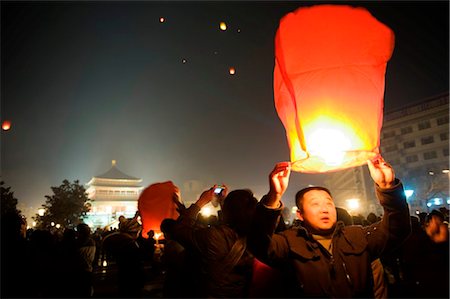 China, Shaanxi Province, Xian, lanterns being released into the sky on New Years Eve Stock Photo - Rights-Managed, Code: 862-03736506