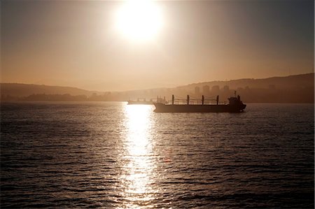 Chile, Port of Valparisio. At sunrise frieghters ride thier anchors at entrance to Valpariso Port. Stock Photo - Rights-Managed, Code: 862-03736632