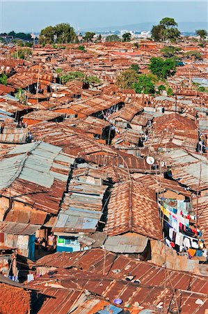 Kenya, Nairobi. A crowded part of Kibera, one of Nairobi s largest slums, with the city centre visible in the distance Stock Photo - Rights-Managed, Code: 862-03736764