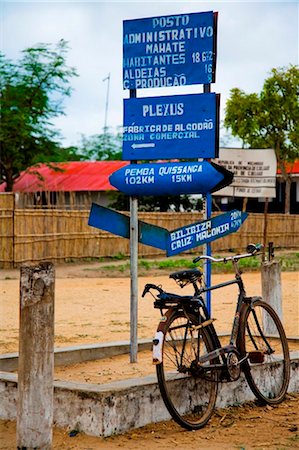 Mozambique. A bicycle laning against a detailed signpost. Stock Photo - Rights-Managed, Code: 862-03736974