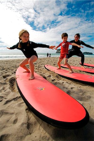 New Zealand, North Island, Coromandel Peninsula. Family surf lesson with Ricky Parker of Whangamata Surf School. Stock Photo - Rights-Managed, Code: 862-03737030