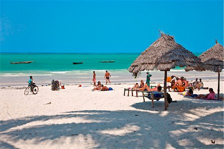 Tanzania, Zanzibar. Tourists sunbathe on Paje Beach, one of the finest white sandy beaches in the southeast of Zanzibar Island. Stock Photo - Rights-Managed, Code: 862-03737279