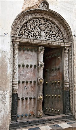 door old opened not people - Tanzania, Zanzibar, Stone Town. Door of a house that belonged to Tippu Tip, the richest of Zanzibars late c19th slave traders. Stock Photo - Rights-Managed, Code: 862-03737315