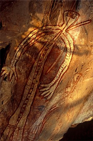 Australia, Northern Territory, Kakadu National Park. An Aboriginal spirit figure at Nangguluwur Gallery at the base of Nourlangie Rock Fotografie stock - Rights-Managed, Codice: 862-03730945