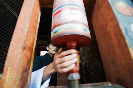 Asia, bhutan, Chokor Valley, Bumthang, Jakar,Jampay Lhakhang, (built 659 by King Songtsen Gampo) Spinning a prayer wheel Stock Photo - Rights-Managed, Code: 862-03730978