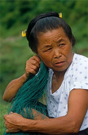 simsearch:862-03289833,k - China, Guizhou Province, nr Rongjiang. A Dong minority woman with a comb wedged into her bun. Fotografie stock - Rights-Managed, Codice: 862-03731131