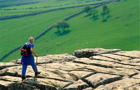 simsearch:862-03710998,k - Walker crossing the limestone platform above Malham Cove, Yorkshire Dales National Park, England Stock Photo - Rights-Managed, Code: 862-03731162