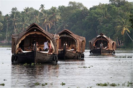 India, Kerala. A trio of houseboats approaching along a channel in the Kerala Backwaters. Stock Photo - Rights-Managed, Code: 862-03731385