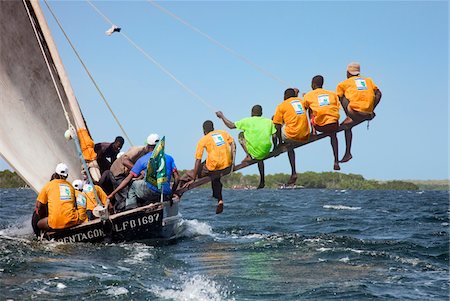 racing sailboats - Kenya. A Mashua sailing boat with an outrigger participating in a race off Lamu Island. Stock Photo - Rights-Managed, Code: 862-03731522