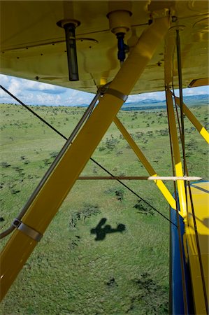 Kenya, Laikipia, Lewa Downs. Will Craig flies his 1930s style Waco Classic open cockpit bi-plane as the ultimate aerial safari. Stock Photo - Rights-Managed, Code: 862-03731584
