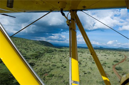 Kenya, Laikipia, Lewa Downs. Will Craig flies his 1930s style Waco Classic open cockpit bi-plane as the ultimate aerial safari. Stock Photo - Rights-Managed, Code: 862-03731585