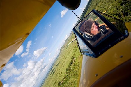 Kenya, Laikipia, Lewa Downs. Will Craig flies his 1930s style Waco Classic open cockpit bi-plane for ultimate aerial safaris. Stock Photo - Rights-Managed, Code: 862-03731625