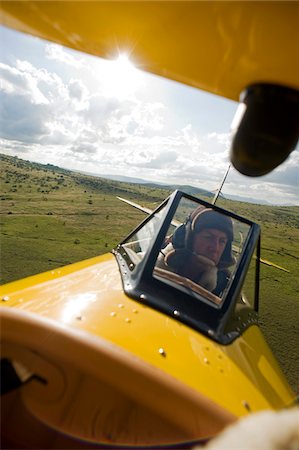 simsearch:6102-05655447,k - Kenya, Laikipia, Lewa Downs. Will Craig flies his 1930s style Waco Classic open cockpit bi-plane for ultimate aerial safaris. Foto de stock - Con derechos protegidos, Código: 862-03731628