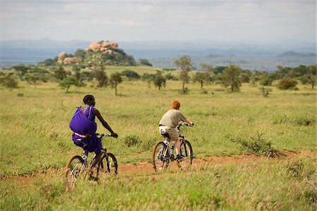 simsearch:862-03731582,k - Kenya, Chyulu Hills, Ol Donyo Wuas. A Maasai guide and boy on a mountain biking safari. Foto de stock - Con derechos protegidos, Código: 862-03731646