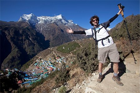 simsearch:862-06542503,k - Nepal, Everest Region, Namche Bazaar, Khumbu Valley. Trekkers on the Everest Base Camp trail looking back over Namche Bazaar Stock Photo - Rights-Managed, Code: 862-03731933