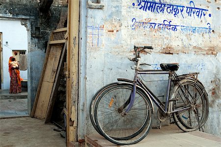 India, Rajasthan, Narlai.   Bikes rest outside the doors of a traditional house in the remote village of Narlai. Stock Photo - Rights-Managed, Code: 862-03807502