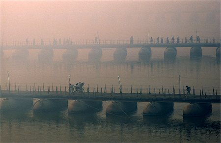India, Uttar Pradesh, Allahabad. Temporary pontoon bridges across the River Ganges are built to help ease the vast numbers of pilgrims attending the celebrated Kumbh Mela festival held here every twelve years. Stock Photo - Rights-Managed, Code: 862-03807579