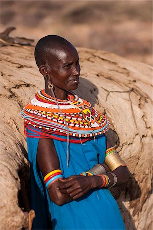 simsearch:862-03352642,k - Kenya, Samburu District.  A Samburu woman, wearing intricate beaded necklaces, leans against her mud hut towards the end of the day. Stock Photo - Rights-Managed, Code: 862-03807765