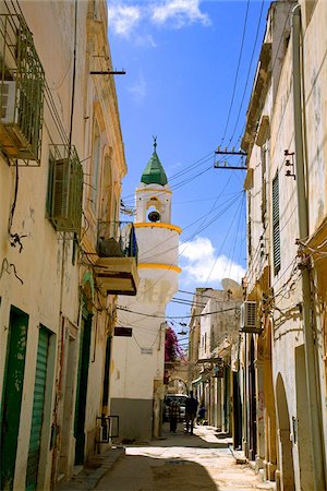 Tripoli, Libya; One of the typical streets in the old Medina of Tripoli with a minaret from a Mosque prominent in the background Stock Photo - Rights-Managed, Code: 862-03807884