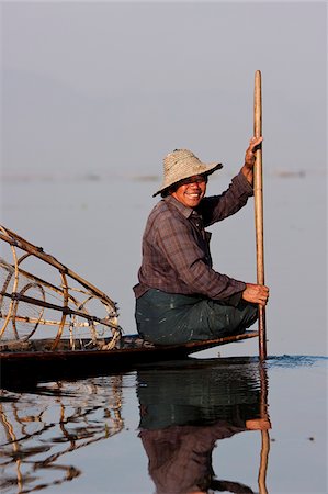 simsearch:862-03807993,k - Myanmar, Inle Lake.  Intha fisherman gently paddling his boat across Inle Lake, Myanmar. Stock Photo - Rights-Managed, Code: 862-03807995