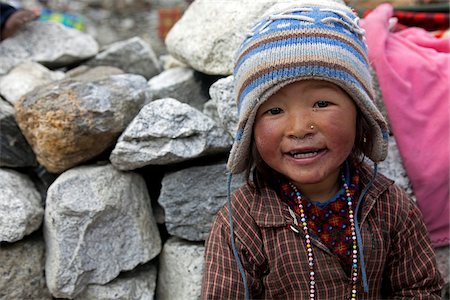 porter - Nepal, Everest Region, Khumbu Valley. On the Everest Base Camp Trail a young Sherpa boy smiles for the camera Stock Photo - Rights-Managed, Code: 862-03808046