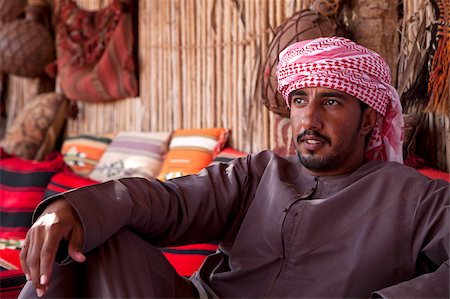 Oman, Wahiba Sands. A guide relaxes at the Nomadic Desert Camp. Stock Photo - Rights-Managed, Code: 862-03808143