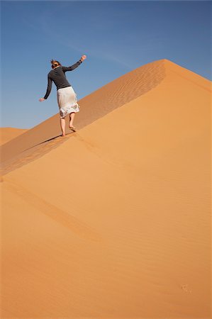 simsearch:862-05998271,k - Oman, Empty Quarter. Une jeune femme a fait son chemin vers le haut des dunes abruptes. Photographie de stock - Rights-Managed, Code: 862-03808175