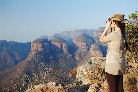 Woman looking through binoculars at Three Rondavels, Blyde River Canyon, Drakensberg Escarpment, Mpumalanga, South Africa Stock Photo - Rights-Managed, Code: 862-03808237