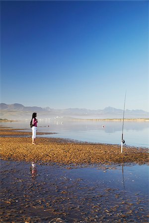 Woman standing on beach, Plettenberg Bay, Western Cape, South Africa Stock Photo - Rights-Managed, Code: 862-03808522