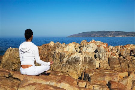 Woman practicing yoga on rocks, Plettenberg Bay, Western Cape, South Africa Stock Photo - Rights-Managed, Code: 862-03808534