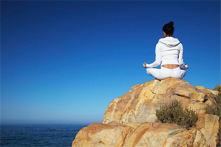 Woman practicing yoga on rocks, Plettenberg Bay, Western Cape, South Africa Stock Photo - Rights-Managed, Code: 862-03808531