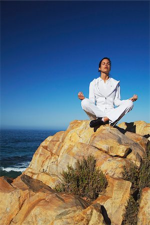 Woman practicing yoga on rocks, Plettenberg Bay, Western Cape, South Africa Stock Photo - Rights-Managed, Code: 862-03808532