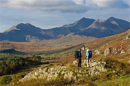 snowdon - North Wales, Snowdonia.  A man and woman stop to look at their map whilst hiking in Snowdonia. Stock Photo - Rights-Managed, Code: 862-03808804