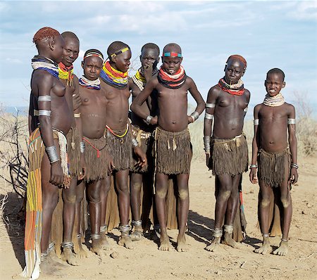 simsearch:862-06676735,k - A group of Nyangatom girls and women with beautifully decorated leather skirts gather to dance.The Nyangatom are one of the largest tribes and arguably the most warlike people living along the Omo River in Southwest Ethiopia. Stock Photo - Rights-Managed, Code: 862-03820544