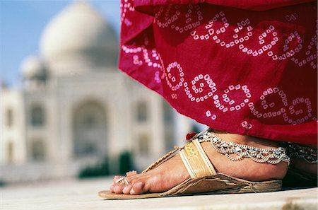 Indian foot & sari detail in front of the Taj Mahal, Agra.The Taj Mahal was built by a Muslim, Emperor Shah Jahan in the memory of his dear wife and queen Mumtaz Mahal.It is an elegy in marble or some say an expression of a dream. Stock Photo - Rights-Managed, Code: 862-03820605