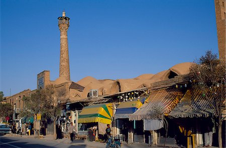 Masjed e Jame minaret and bazaar, Semnan, Semnan Province, Iran. Seljuk period, first half of 11th century.The Masjed e Jame  is in the heart of the bazaar, further evidence of the way in which, for people of the Silk Road, faith and commerce were frequently intertwined. Stock Photo - Rights-Managed, Code: 862-03820629