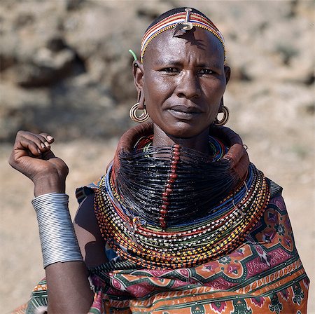 A Samburu woman wearing a mporro necklace, which denotes her married status. These necklaces were once made of hair from giraffe tails but nowadays, the fibres of doum palm fronds, Hyphaene coriacea, are used instead.The red beads after which the necklace is named are wound glass beads made in Venice c.1850. Stock Photo - Rights-Managed, Code: 862-03820646