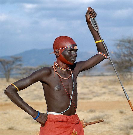 A month after a Samburu youth has been circumcised, he becomes a warrior.He will go to the nearest stream or Waterhole to wash off a months grime.He then decorates himself with a mixture of ochre and animal fat, and adorns himself with beads. The sudden change in his appearance is remarkable. Stock Photo - Rights-Managed, Code: 862-03820648