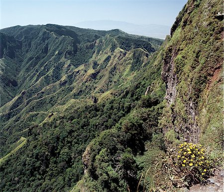 Mount Kulal is divided into two by an ancient volcano, which collapsed thousands of years ago, leaving an impressive gorge. This picture shows the remains of the steep sided volcanic crater. Mount Kulal rises to over 6,000 feet in Northern Kenya and is surrounded by a sea of lava and arid wastes. Stock Photo - Rights-Managed, Code: 862-03820671